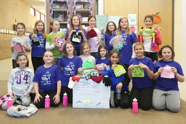 Girls on the Run members with the hats, mittens, gloves and scarves that they collected for the Boys and Girls Clubs of America. (Photo provided)