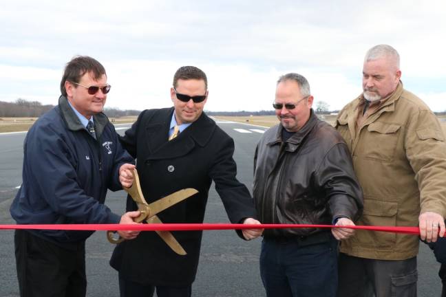 From left: Ed Magryta, Orange County&#x2019;s Director of Aviation, Orange County Executive Steven M. Neuhaus, Chairman of the Legislature Steve Brescia and Town of Montgomery Supervisor Rod Winchell on Orange County Airport&#x2019;s new runway (Photo provided)