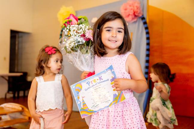 Isabella Chiappone, 4, after receiving her moving up certificate. Photos by Sammie Finch.