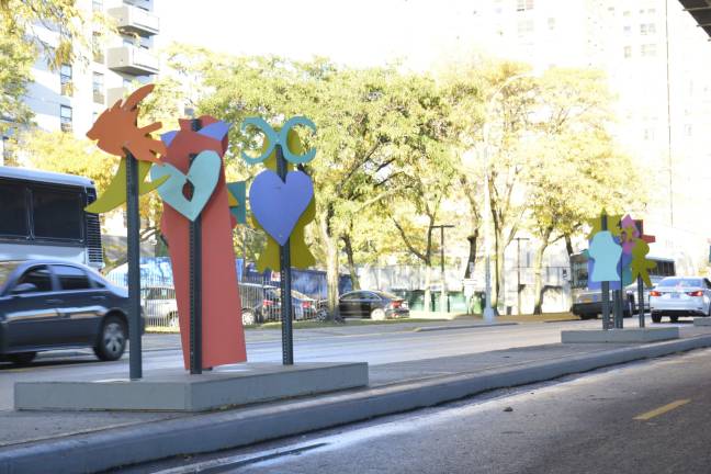 A six-foot median separating a two-way bike lane on South Street is bedecked by abstract, colorful figures. Photo: Diamond Naga Siu
