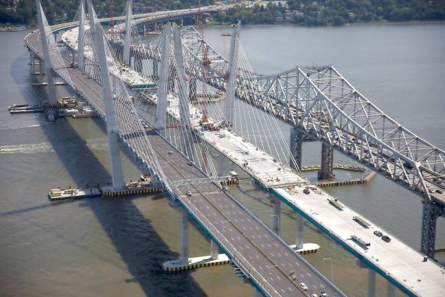 A view of the Tappan Zee Bridge on the far right and construction of what would become the Gov. Mario Cuomo Bridge during its construction. Incidentally, the original Tappan Zee Bridge was renamed the Malcom Wilson Tappan Zee Bridge in 1994 in honor of the former governor. Photo source: mariomcuomobridge.ny.gov.