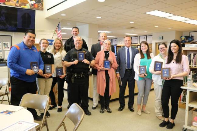 Various local businesses, organizations, and professionals partnered with Chester Academy to mentor the students in its internship program. Left to right: Chester Academy Assistant Principal and Athletic Director Rolando Aguilar, Jessie Blitz of Garden State Koi &amp; Waterfall Design, Shirley Brewer of the Orange County Sheriff’s Office, Town of Chester Police Department’s Bruce Chambers and Norman Vitale, David Wilson and Nan Wilson of Willy Gilly Productions, Bon Secours Medical Group’s Dr. Richard Evans, Chester Academy Math Teacher Danielle Burton, Chester Academy English Teacher Lisa Edwards, and Chester Academy Music Teacher Rachel Scali. Photo provided.