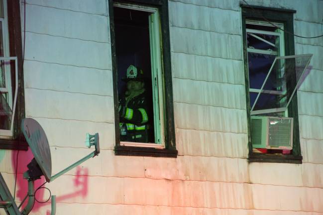 Goshen, NY Jan 13 2018. Firefighter checks the inside of the building