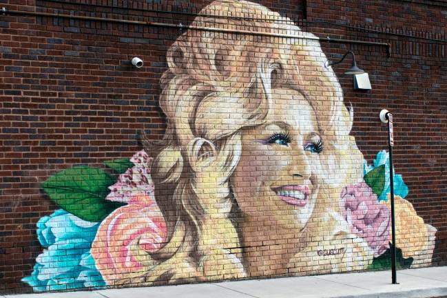 You could find this artwork of Dolly Parton on Haywood Road in West Asheville, N.C. Photo by Wes McFee on Unsplash.