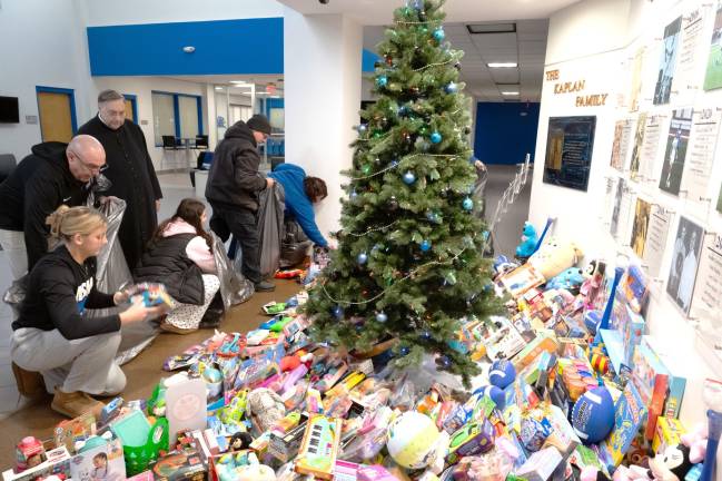 Mount Saint Mary College students and staff sort and bag hundreds of toys collected during the college’s annual Christmas drive.
