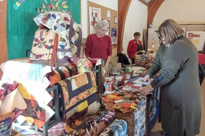 Customers admire quiltwork upstairs at the craft fair at First Presbyterian