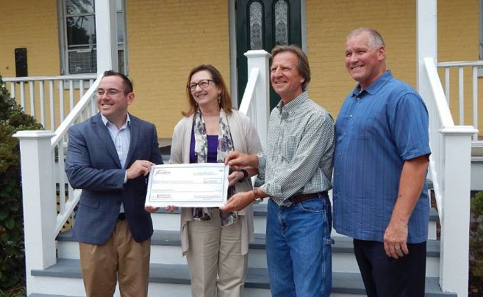 From left, Village of Goshen Mayor Kyle Roddey; Deb Bogdanski, general manager of Frontier Communications; Gerry Hluchen; and Terry Smallin, executive director of the Goshen Chamber of Commerce, were on hand for the transfer of Frontier's symbolic $5,000 check.