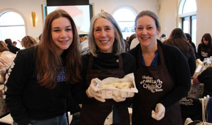 Three generations of women recited the blessing on separating the Challah dough at the Jewish Women’s Circle’s Mega Challah Babka Bake. Pictured are Hailey Leonard with mother Heidi and Grandmother Marion Wagner.