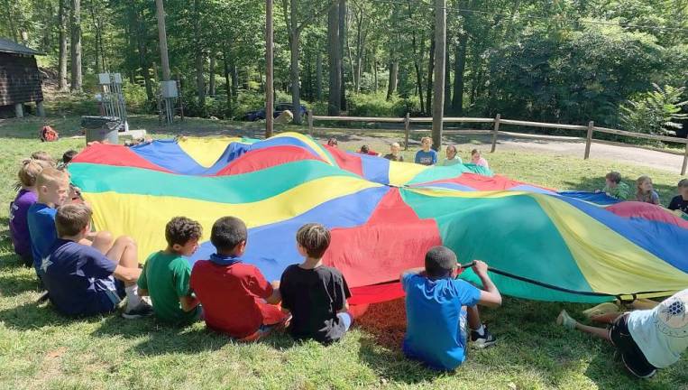 You're never too old for some parachute games like this one at the YMCA Camp Discovery in Harriman State Park. Photo by Kayla Hartigan.