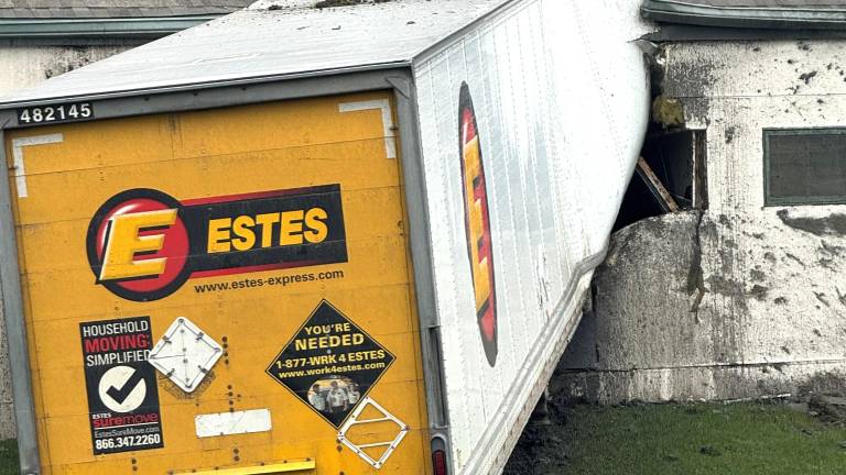 A tractor-trailer traveling south on Hatfieled Lane lost control and struck a fire hydrant, utility box and building.