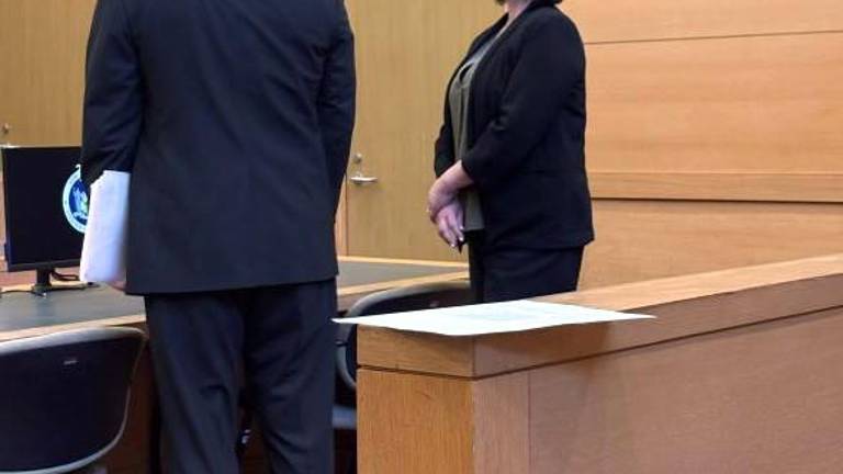 Selina Nelson-Reilly speaks to her attorney April 10 in county court.