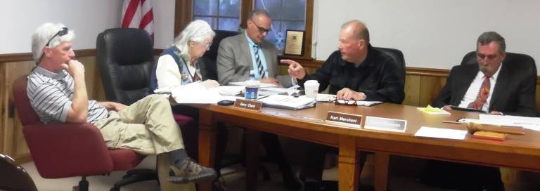 Planning Board member Karl Merchant points a fingerat Supervisor Gary Clark, far left, in a heated discussion. (Photo by Anya Tikka)