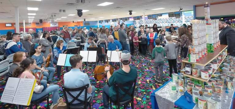 The Allegro Youth Orchestra plays Hanukkah songs at the “Can-orah” celebration at Colonial Lanes in Chester.