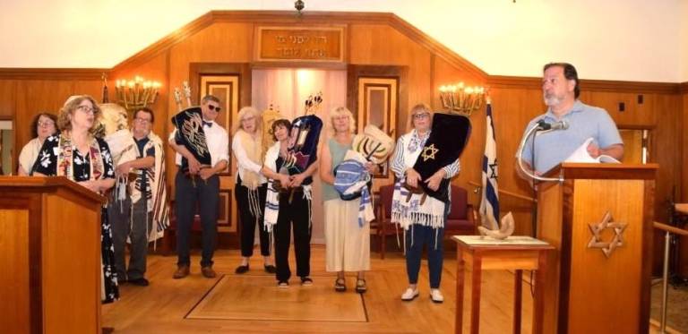 Rabbi Rebecca Shinder of Temple Beth Shalom of Florida (right) joins Rabbi Roger Lerner of Monroe Temple Beth-El in welcoming the Torahs (and congregants) from Monroe Temple to Florida, N.Y.