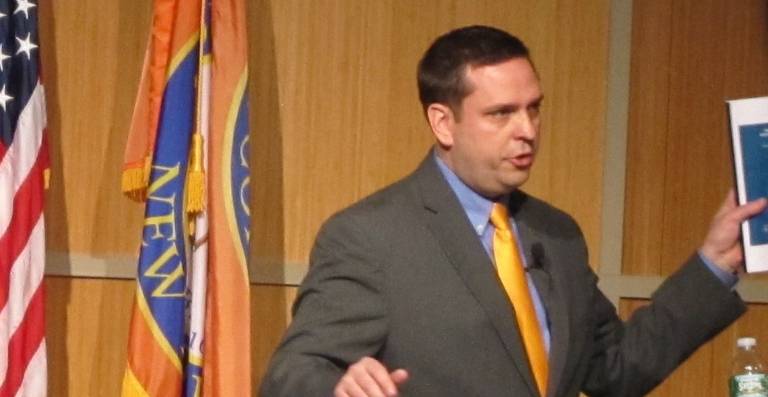 County Executive Steve Neuhaus shows charts depicting the county's financial troubles. (Photo by Edie Johnson)