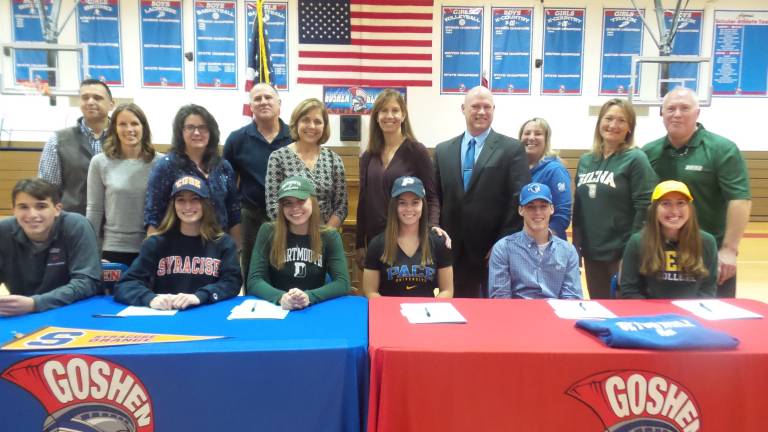 Senior athletes Morgan Serkes, Justin Lorenzo, Ryan Lutz, Mackenzie Kurek, Kate Laskoski and Olivia Elston are pictured on signing day with their parents. (Photo by Frances Ruth Harris)