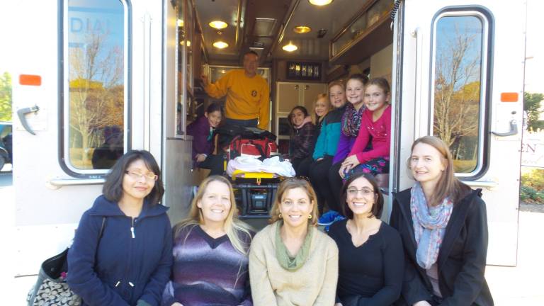 From left: Aliana Vanichpong, Captain John Gippe, Alissa Cecere, Paulina Bowman Carroll, Kyla Kropp, Ella O'Brien Buruno, and Kristin McClintock (Photo by Frances Ruth Harris)