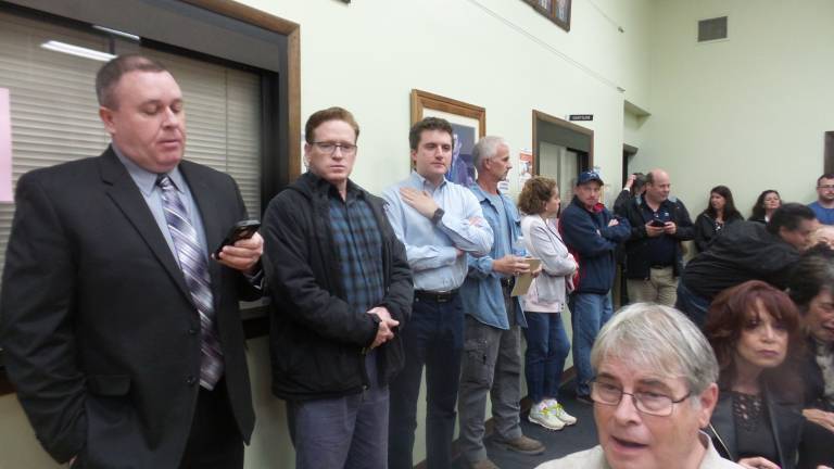 New York State Assemblyman James Skoufis (third from left) stood along one wall. He later spoke to the group, offering hope and a plan. (Photo by Frances Ruth Harris)