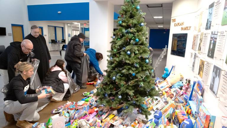 Mount Saint Mary College students and staff sort and bag hundreds of toys collected during the college’s annual Christmas drive.