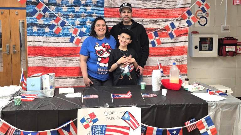 A Chester Elementary School Student and his family stand proudly by their display.