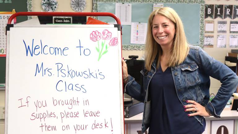 Angela Pskowski, who teaches first grade teacher at Chester Elementary School, welcomes students to class. Photo provided