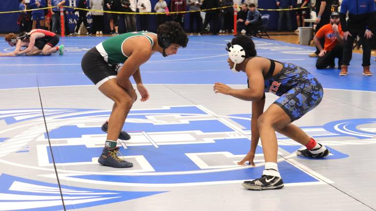 Dominick Jean-Pierre (right) is emerging as a leader in boys wrestling
