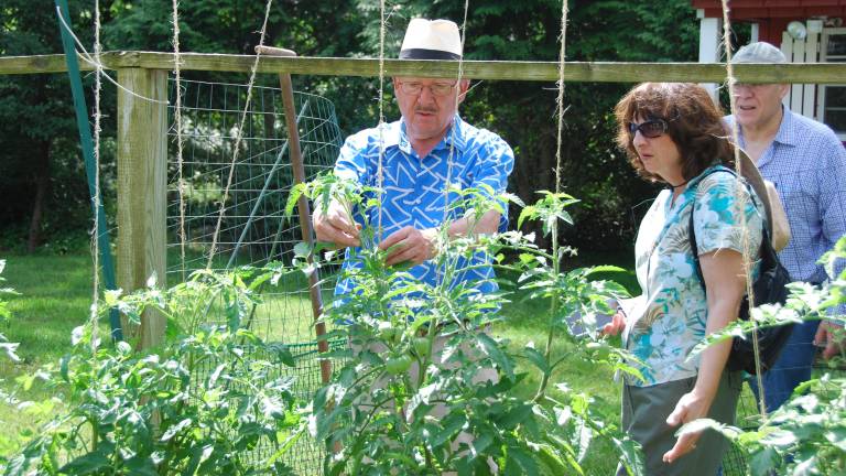 Klaas Vogel shows attendees his bustling veggie garden, featuring custom-made fencing, during a past Kitchen Garden Tour. Vogel is showing his garden again at this year’s event Aug 3.