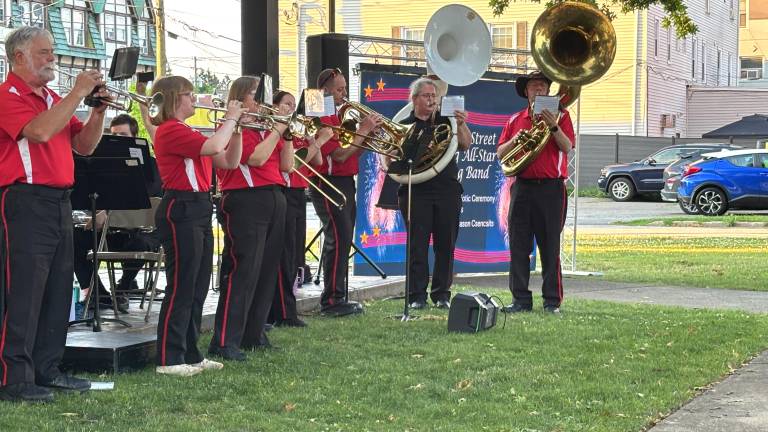 The Broome Street Marching band, with Shary Kranch on the white sousaphone performs at Veterans Park.