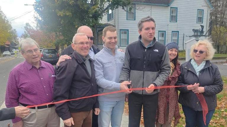 Sen. James Skoufis and Chester Town Supervisor Brandon Holdridge prepare to cut the ceremonial ribbon for the Sugar Loaf sidewalk project on Oct. 31, 2025.