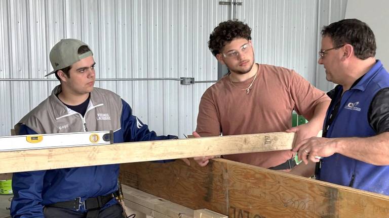 Students at Orange-Ulster BOCES in Goshen work on the modular units for the village for veterans with Corey Miller, Director of Construction Education. Photo provided.