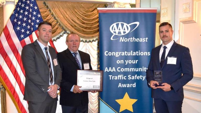 <b>Village of Goshen Police Sergeant David Yates, AAA Vice President of Public &amp; Government Affairs John A. Corlett, and Village of Goshen Police Officer Cody Hunt.</b>