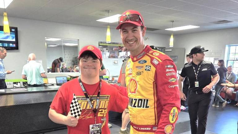 Nathan Dershem with his hero, NASCAR champion Joey Logano, at the Poconos Raceway. Photo provided.