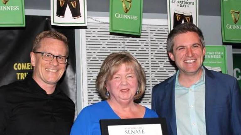 Susan Armistead stands between OC Legislator Jonathan Redeker (left) and Sen. James Skoufis holding a copy of her proclamation.